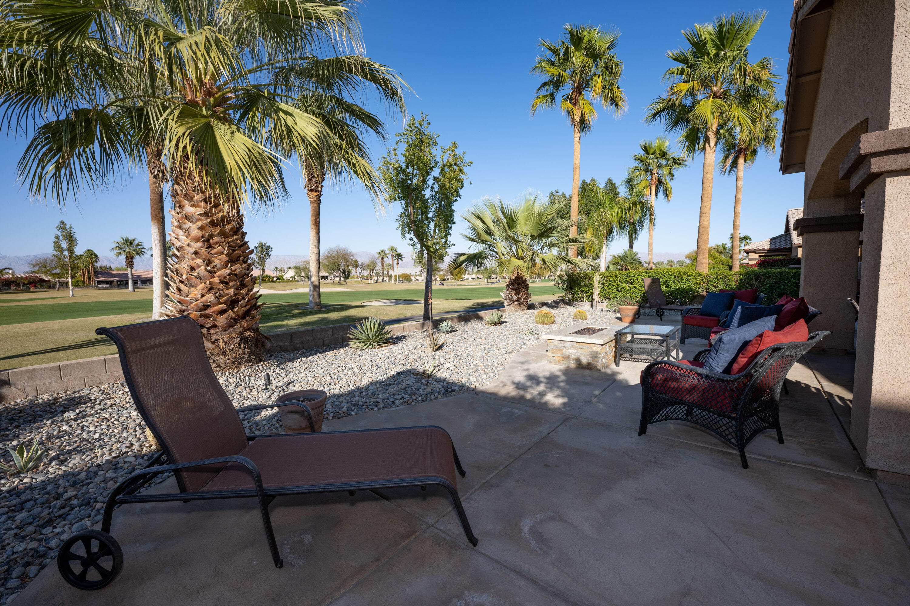 79754 Carmel Valley Avenue Indio, CA 92201 - Photo 23 of 36 a view of a backyard with a patio table and chairs