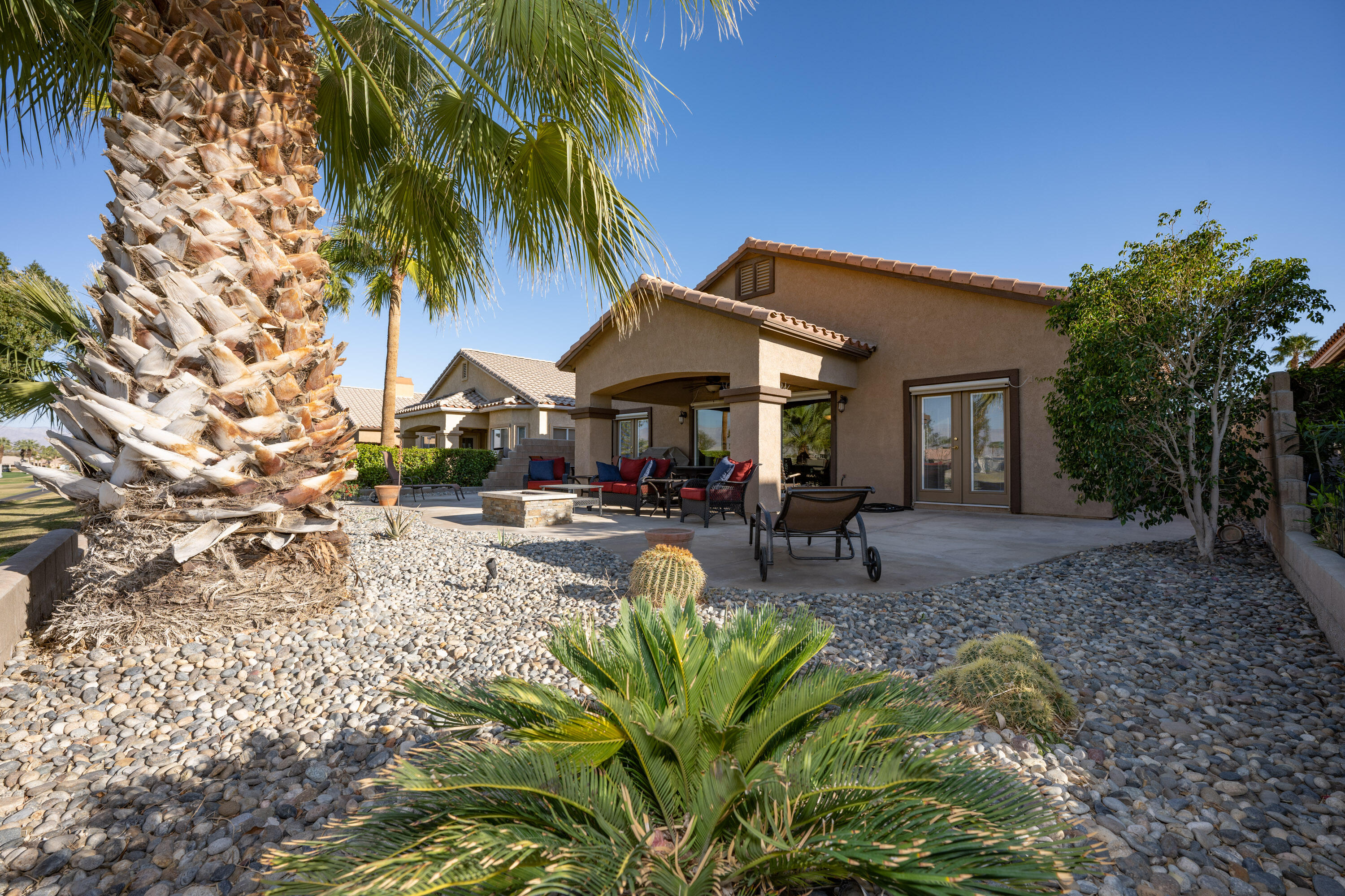 79754 Carmel Valley Avenue Indio, CA 92201 - Photo 24 of 36 a view of a swimming pool with chairs