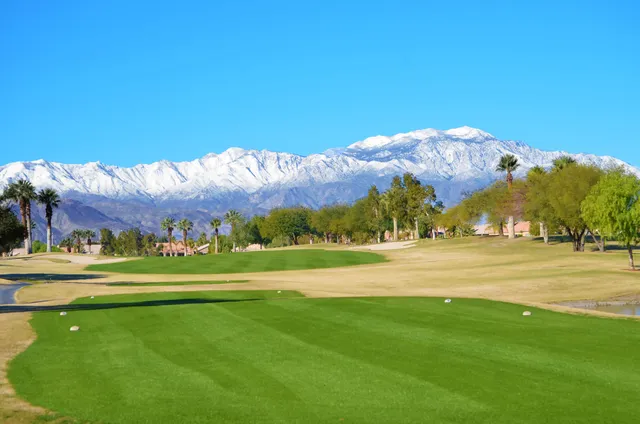 a view of a golf course with a lake view