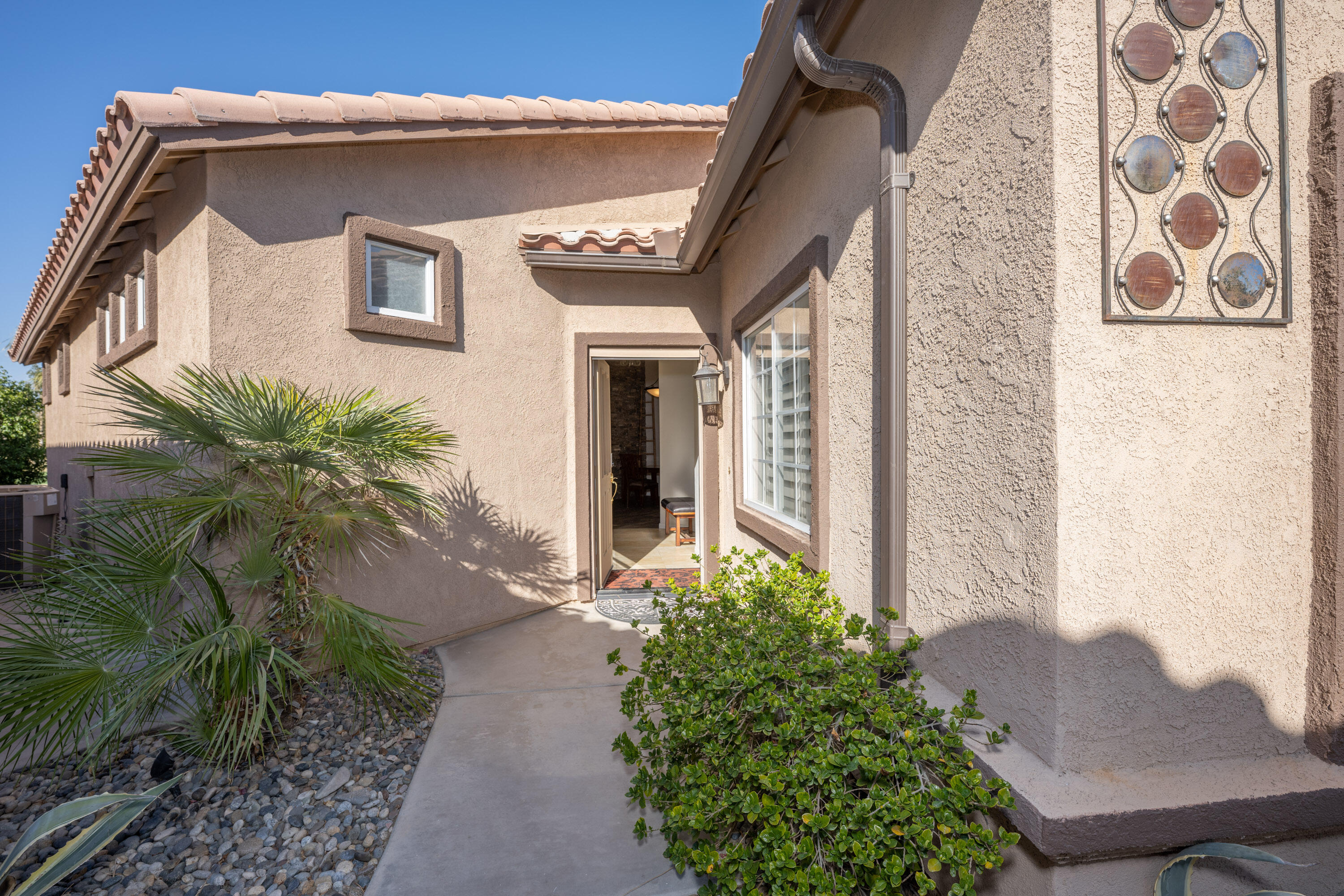 79754 Carmel Valley Avenue Indio, CA 92201 - Photo 6 of 36 a front view of a house with a yard