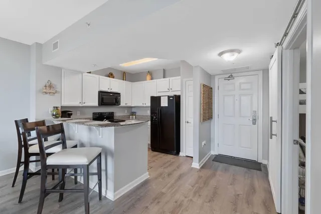 a kitchen with stainless steel appliances a refrigerator stove microwave and cabinets