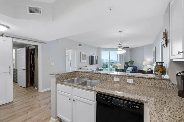 a kitchen with sink and cabinets
