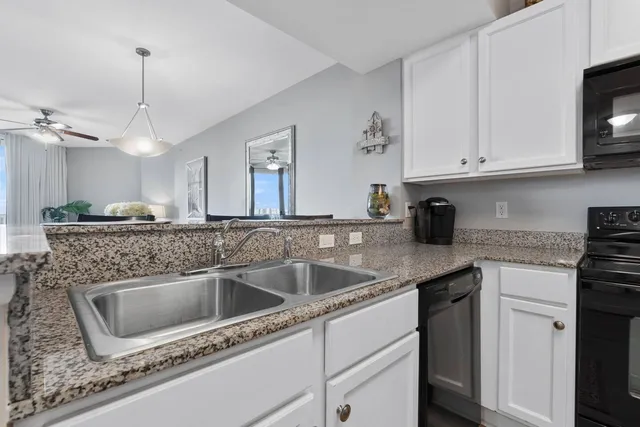 a kitchen with a refrigerator and a stove top oven