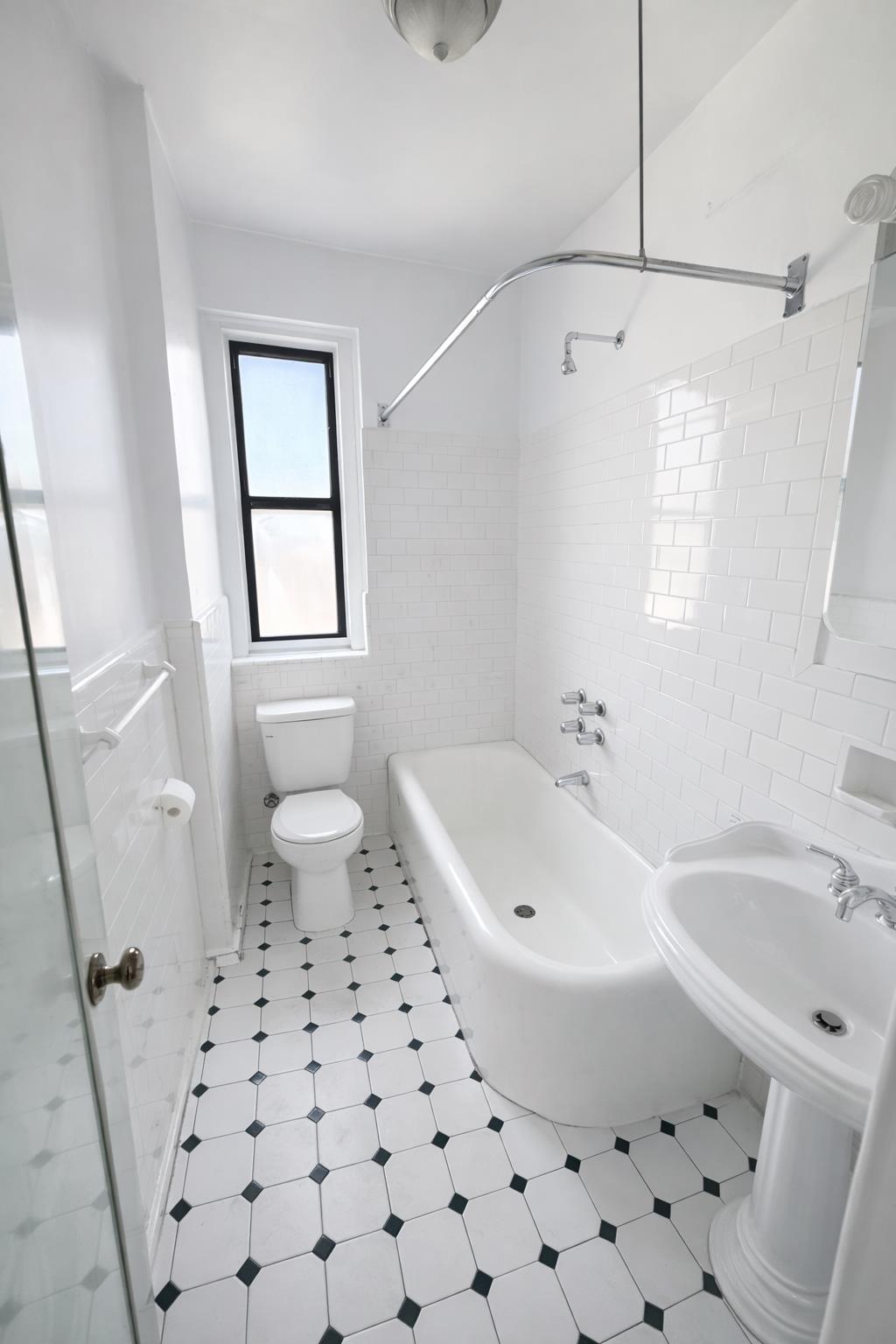1825 Riverside Drive, Unit 5B Manhattan, NY 10034 - Photo 12 of 19 a bathroom with a sink a toilet and a bathtub