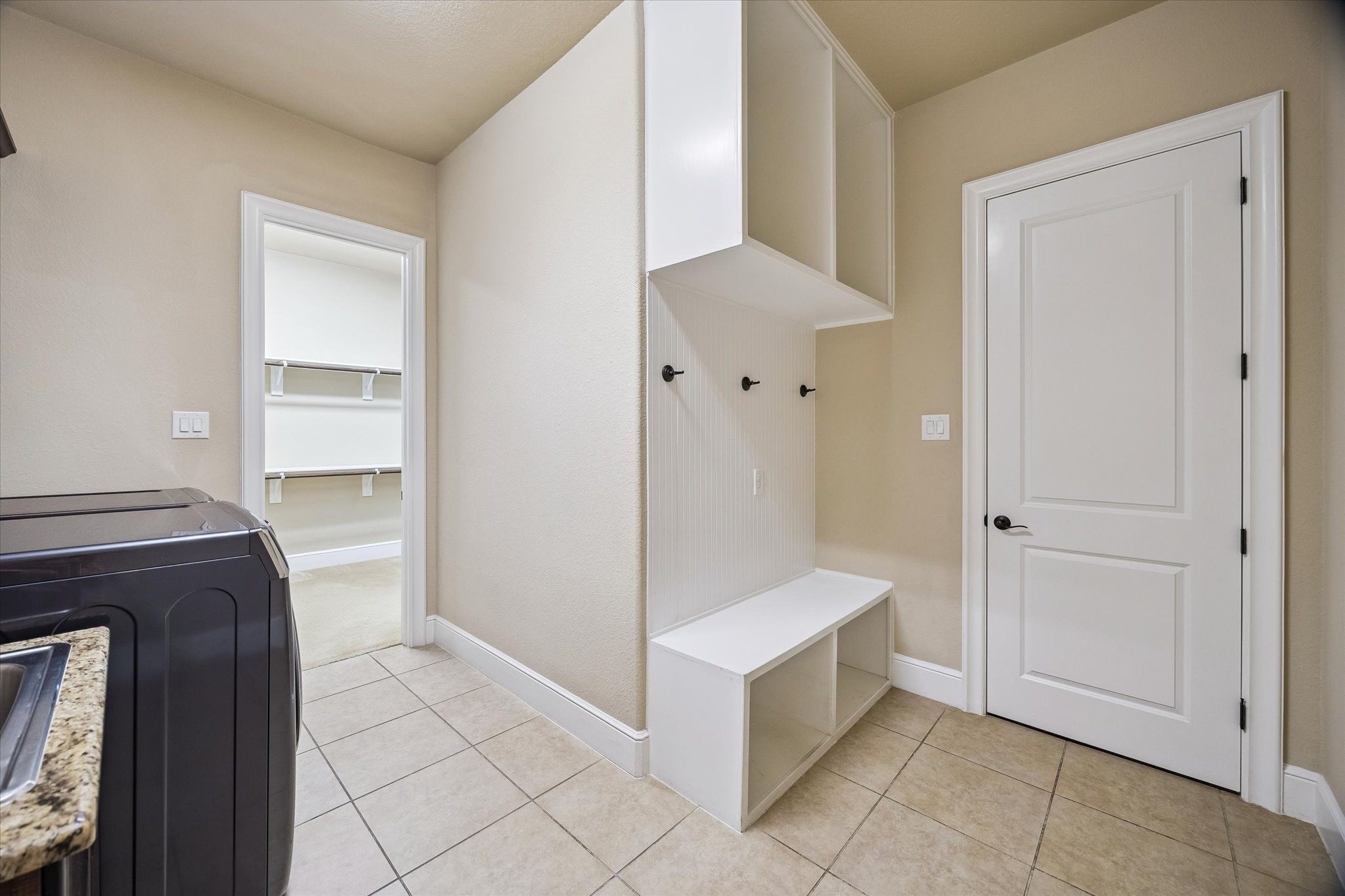 35 North Fremont Ridge Loop Spring, TX 77389 - Photo 17 of 37 Enhancing everyday convenience, the mudroom and laundry area features built-in storage, bench seating, and direct access to the primary closet—an intelligent design feature that promotes organization and efficiency.