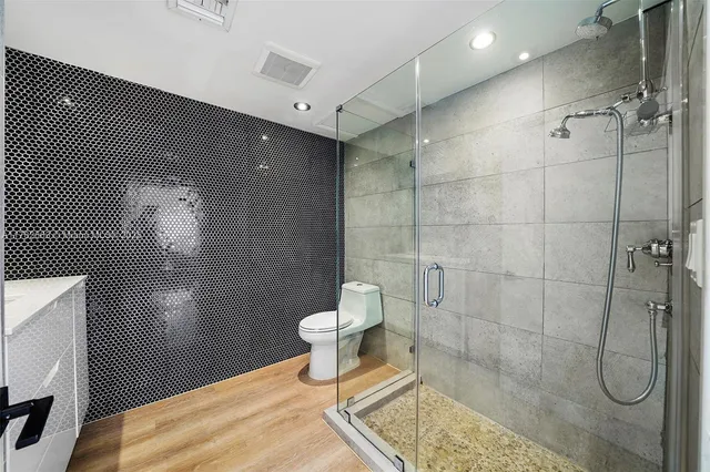 a bedroom with a bed chandelier and window