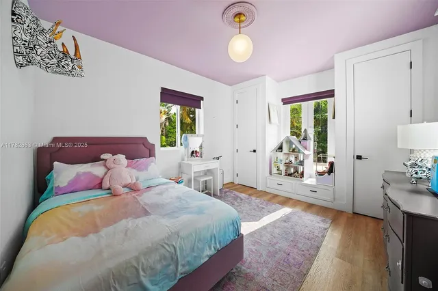 a spacious bedroom with a bed and a chandelier