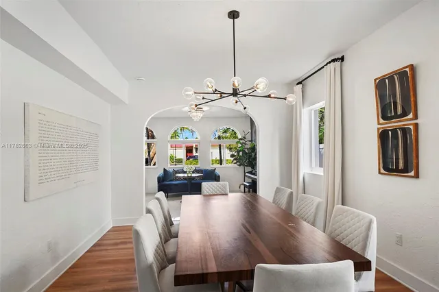 a living room with furniture fireplace and a large window