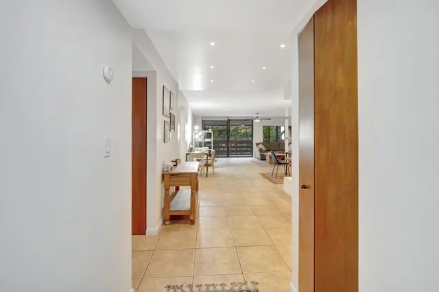 a view of a dining room with furniture large windows and wooden floor