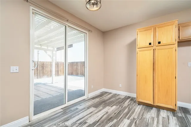 a view of a room with wooden floor and sliding door
