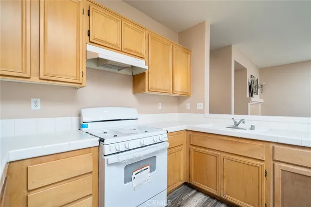 a kitchen with appliances cabinets and a sink