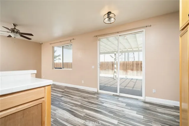 a view of a room with wooden floor and windows