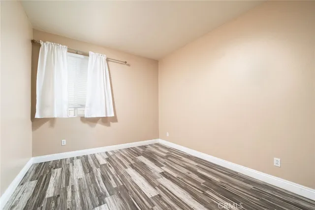 a view of a room with wooden floor and cabinet