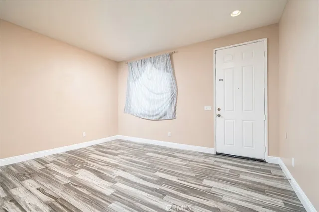 a view of a room with wooden floor and window
