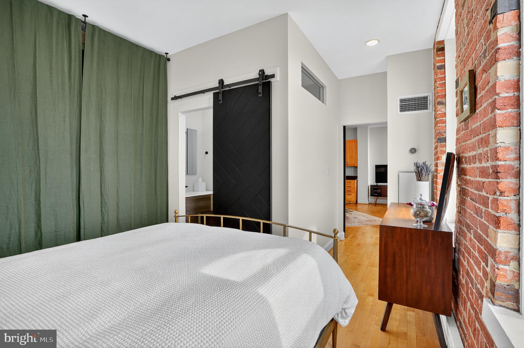 1615 Q Street Northwest, Unit 601 Washington, DC 20009 - Photo 16 of 19 a bedroom with a bed and a mirror