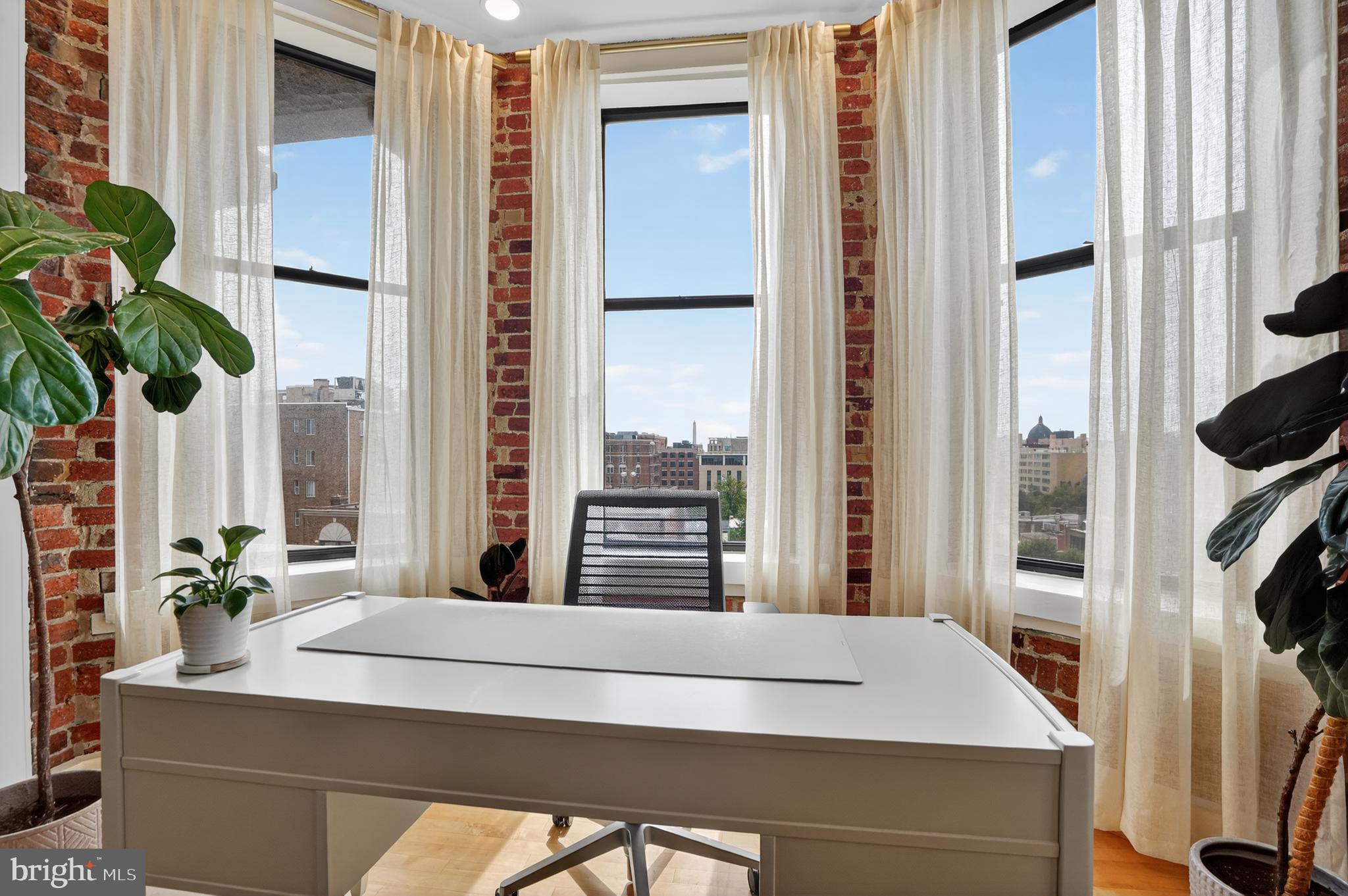 1615 Q Street Northwest, Unit 601 Washington, DC 20009 - Photo 2 of 19 a room with a large window and a potted plant