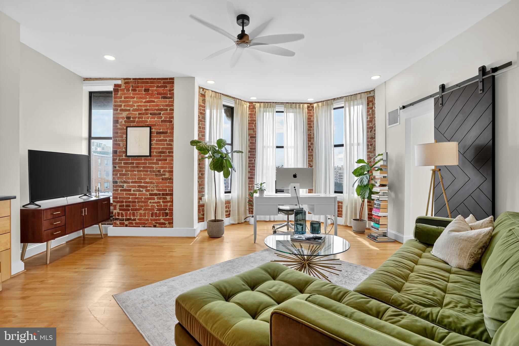 1615 Q Street Northwest, Unit 601 Washington, DC 20009 - Photo 3 of 19 a living room with furniture and a flat screen tv