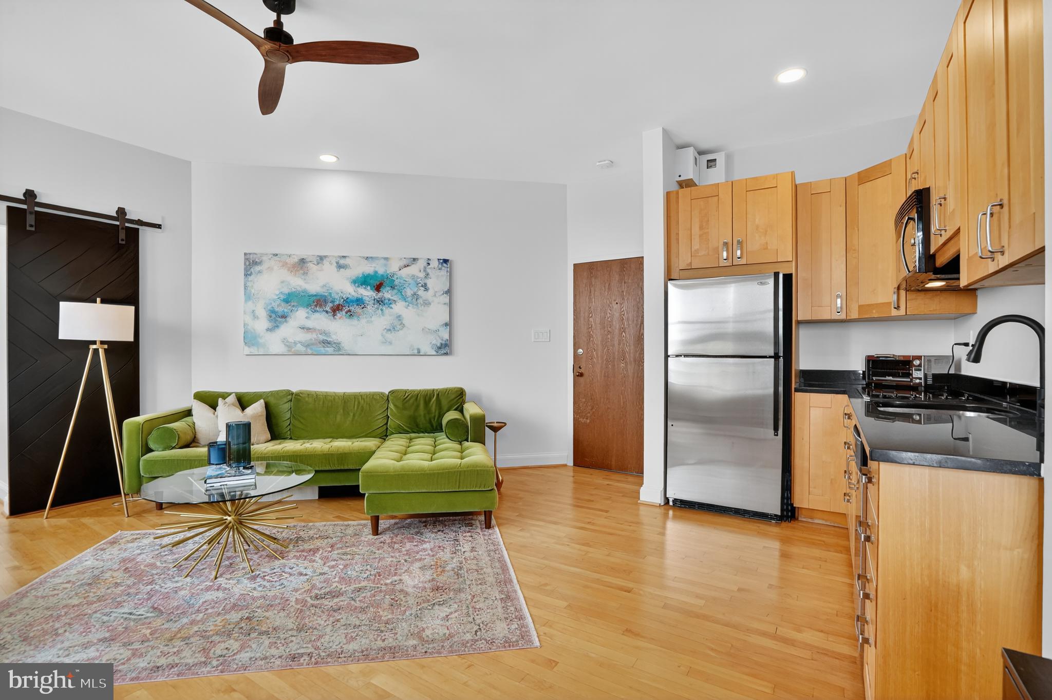 1615 Q Street Northwest, Unit 601 Washington, DC 20009 - Photo 6 of 19 a living room with stainless steel appliances furniture or kitchen view and a wooden floor
