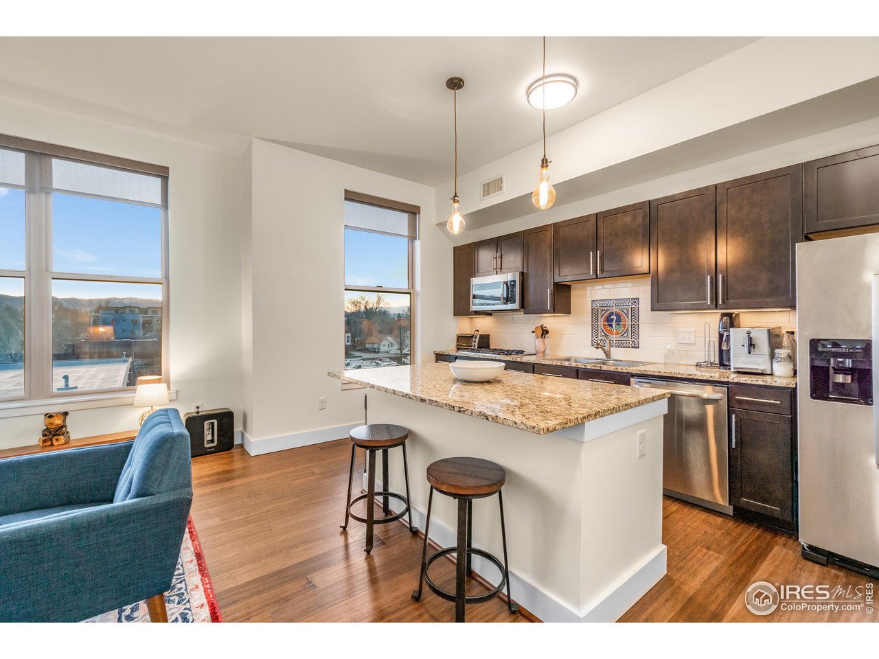 204 Maple Street, Unit 301 Fort Collins, CO 80521 - Photo 12 of 26 a kitchen with kitchen island granite countertop a sink and counter space