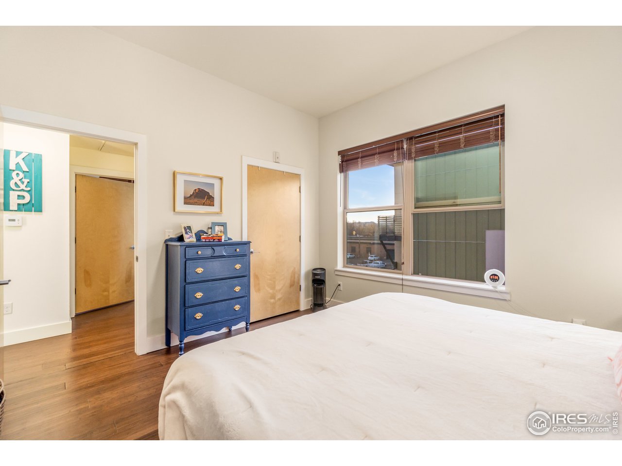 204 Maple Street, Unit 301 Fort Collins, CO 80521 - Photo 16 of 26 a bedroom with a bed and a large window