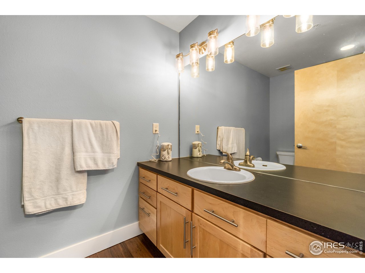 204 Maple Street, Unit 301 Fort Collins, CO 80521 - Photo 18 of 26 a bathroom with a sink and a mirror