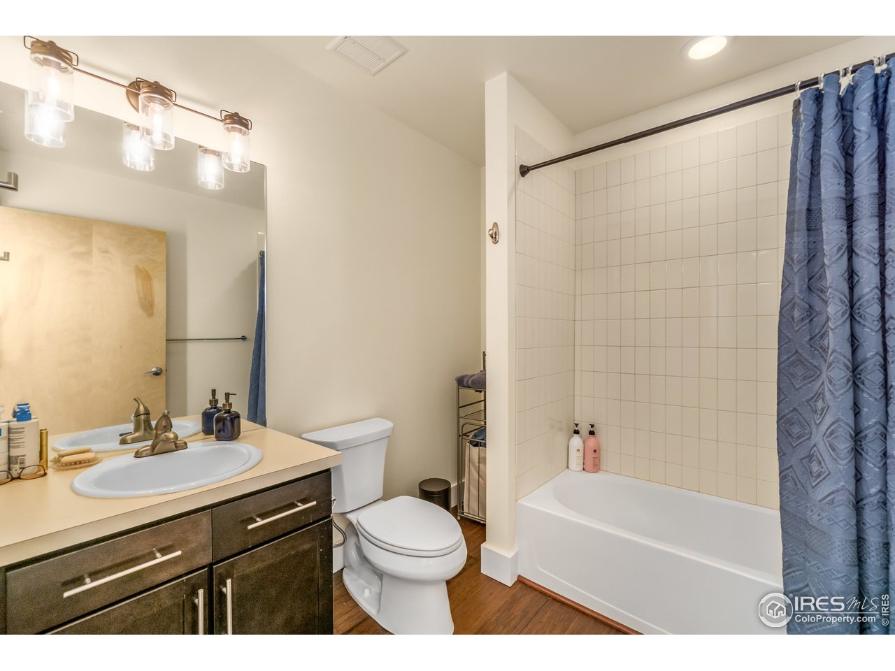 204 Maple Street, Unit 301 Fort Collins, CO 80521 - Photo 21 of 26 a bathroom with a sink a toilet a mirror a bathtub and shower