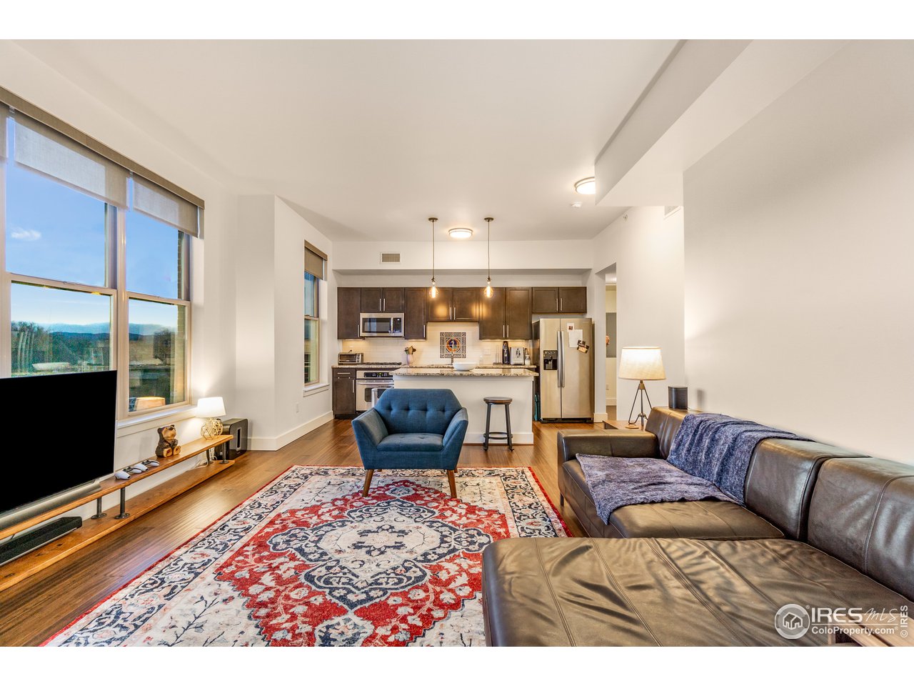 204 Maple Street, Unit 301 Fort Collins, CO 80521 - Photo 3 of 26 a living room with furniture flat screen tv and a table