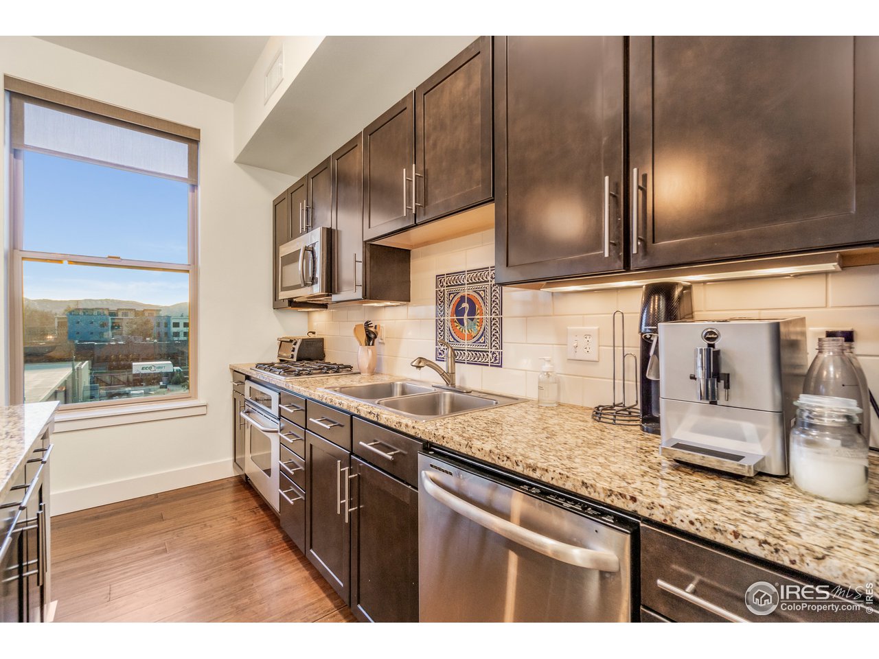 204 Maple Street, Unit 301 Fort Collins, CO 80521 - Photo 9 of 26 a kitchen with stainless steel appliances granite countertop a sink and a stove