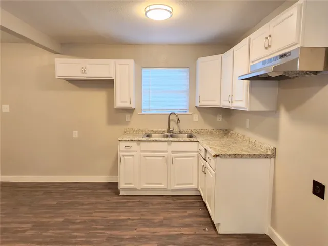 a kitchen with stainless steel appliances granite countertop a sink and cabinets