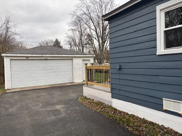 a view of a house with a small yard and wooden fence