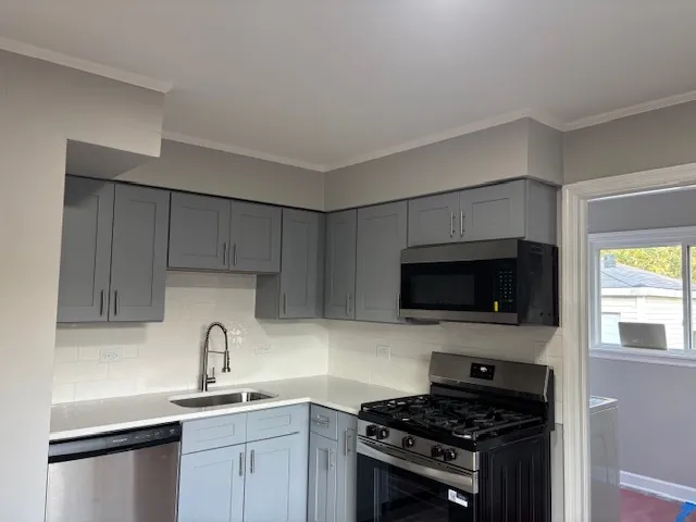 a kitchen with a stove a refrigerator and a window