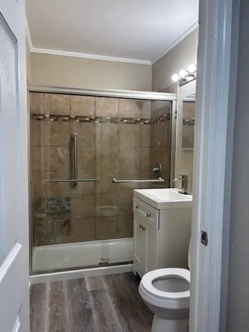 a bathroom with a shower a toilet and sink