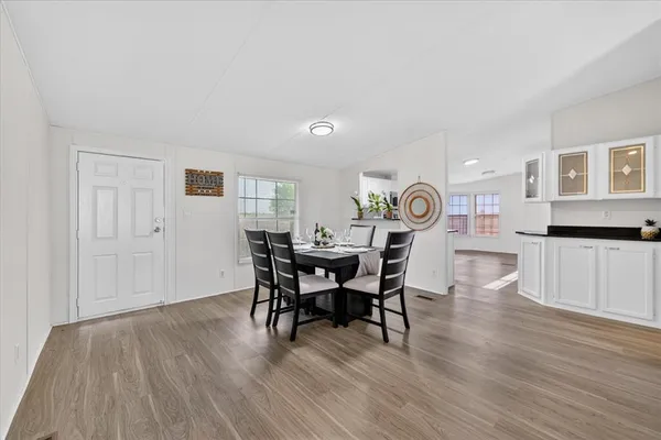 a view of a dining room with furniture and wooden floor
