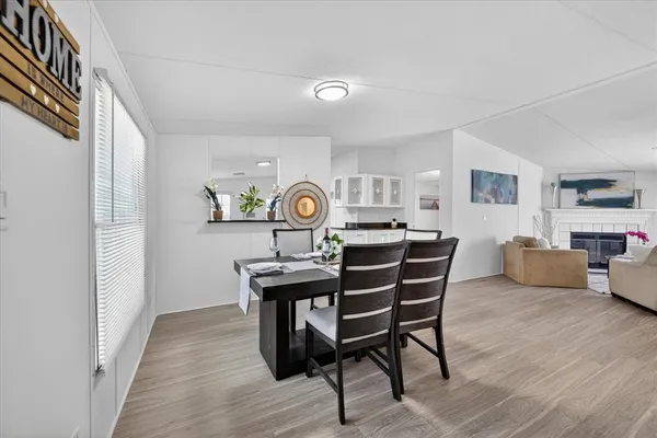 a view of a dining room with furniture and wooden floor