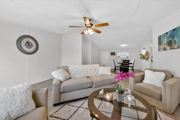 a living room with furniture and a chandelier