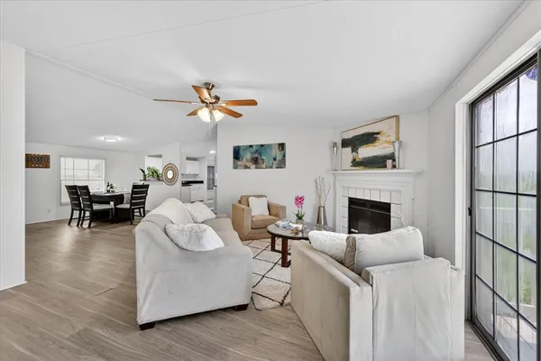 a living room with furniture a fireplace and a flat screen tv