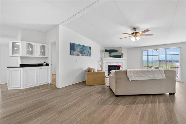 a living room with furniture and a wooden floor