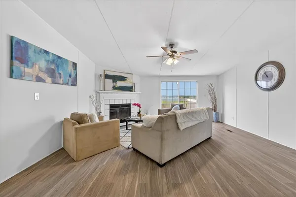 a living room with furniture a fireplace and a large window