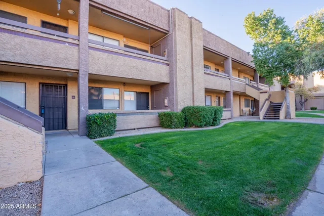 a view of a brick building next to a yard
