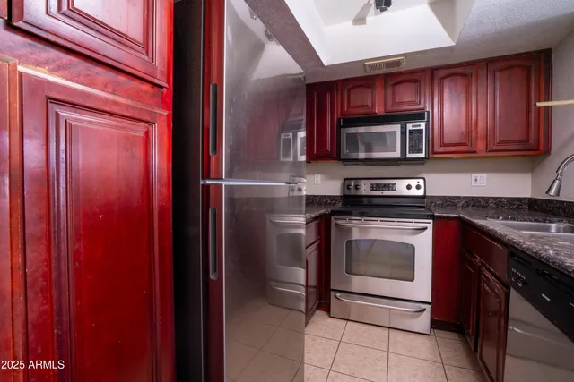 a kitchen with stainless steel appliances granite countertop a stove microwave and sink