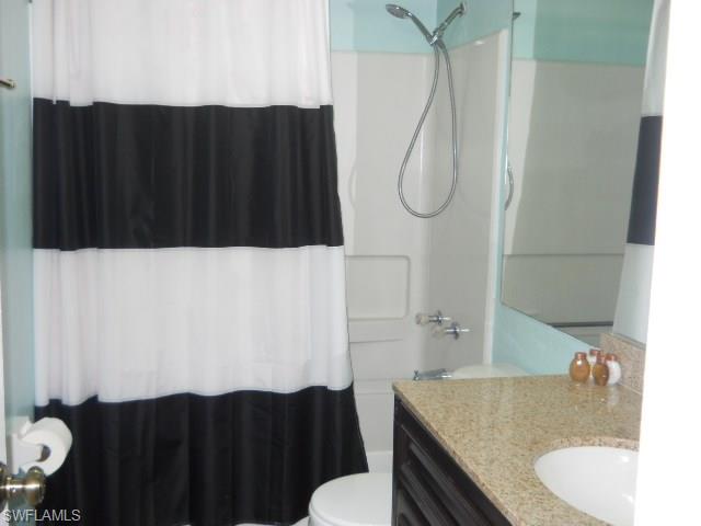 4010 Ice Castle Way, Unit 7 Naples, FL 34112 - Photo 11 of 14 a bathroom with a sink vanity mirror and toilet
