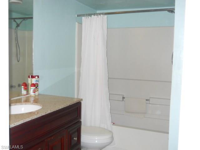 4010 Ice Castle Way, Unit 7 Naples, FL 34112 - Photo 12 of 14 a bathroom with a sink and a mirror