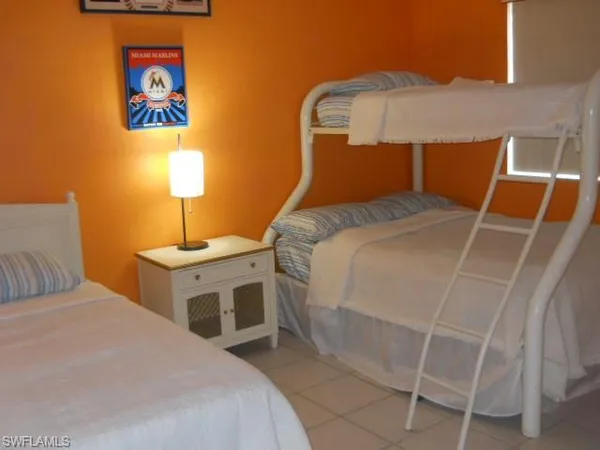 a bedroom with a bed and a lamp on table