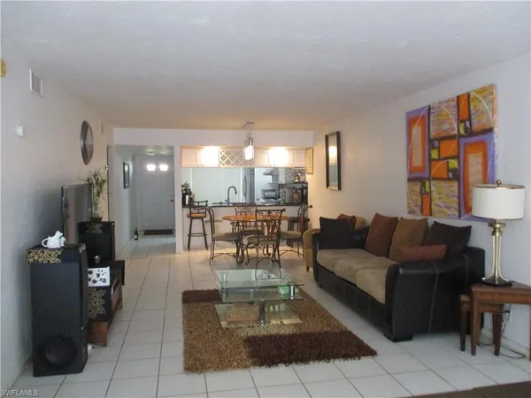 a living room with furniture and a lamp