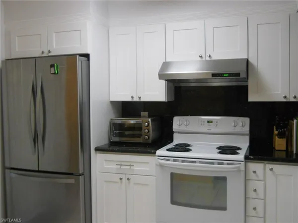 a kitchen with a stove and a refrigerator