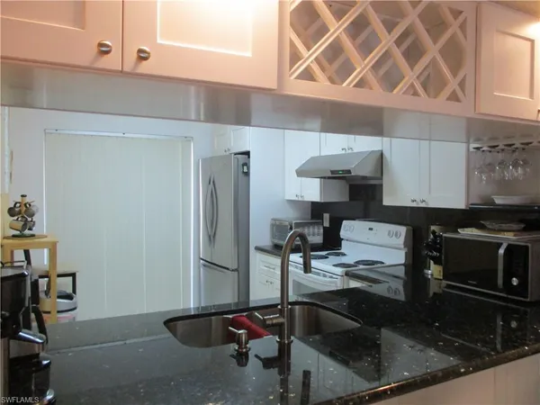 a kitchen with a sink cabinets and appliances