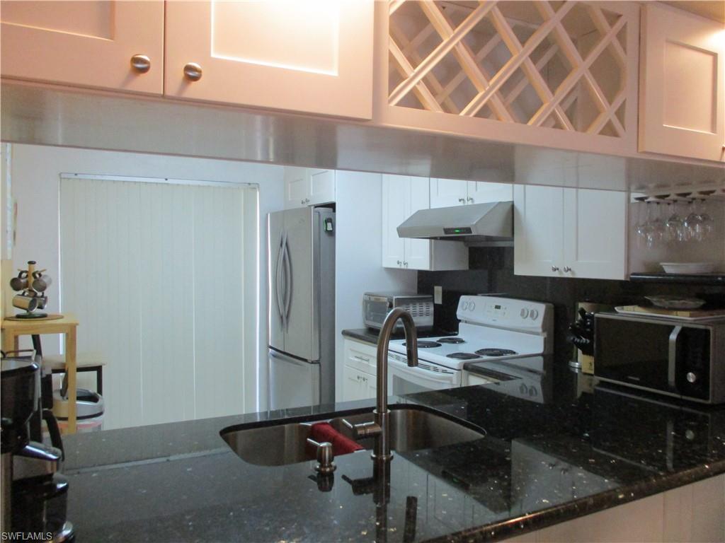 4010 Ice Castle Way, Unit 7 Naples, FL 34112 - Photo 7 of 14 a kitchen with a sink cabinets and appliances