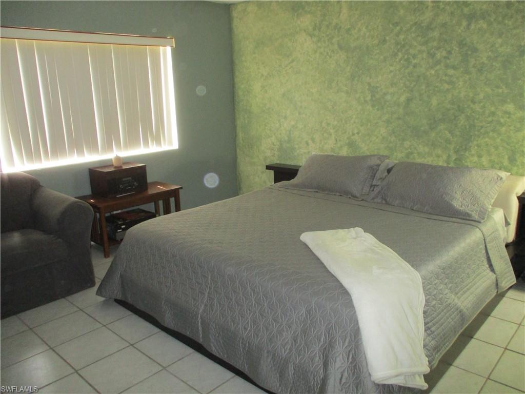4010 Ice Castle Way, Unit 7 Naples, FL 34112 - Photo 9 of 14 a bedroom with a bed and a window