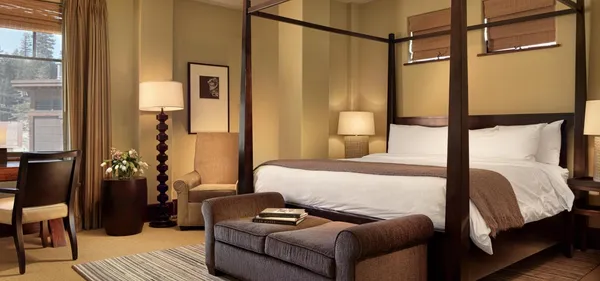 a bedroom with a bed couch and a window