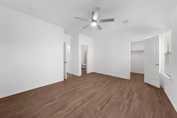 a view of an empty room with wooden floor